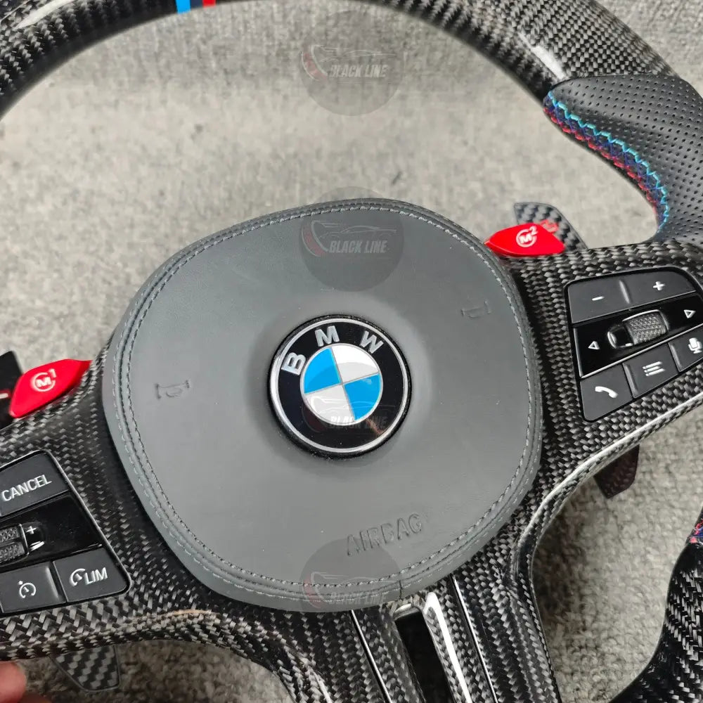 Volante BMW M deportivo en fibra de carbono cuero perforado y botones M1/M2 con airbag incluido